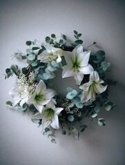 Elegant white amaryllis and fresh green eucalyptus leaves garland hanging on a plain neutral wall, minimalist holiday decoration concept, creating a peaceful and tranquil atmosphere