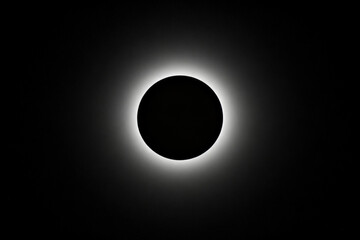 Total solar eclipse with visible corona against dark sky