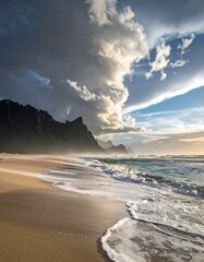 Dramatic coastal scene; dark mountains under stormy skies contrast with sunlit beach and waves