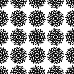 Seamless black and white geometric mandala pattern.