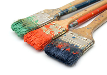 A vibrant artistic display featuring paintbrushes adorned with splashes of green, orange, and blue paint, capturing the essence of creativity and artistic tools.