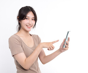 Happy asian girl pointing finger at a mobile phone