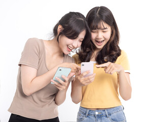 Happy Teenage girls laughing and using mobile phone