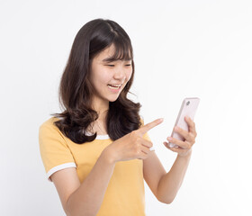 Happy asian girl pointing finger at a mobile phone