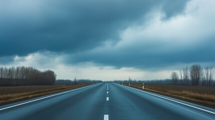 asphalt. Panoramic view of an empty road under cloudy skies, capturing a serene and open landscape. travel magazines, destination branding, designed for outdoor magazines and nature guides.