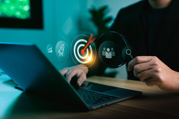 Business analysis and target audience strategy with businessman using laptop computer and magnifying glass focusing on digital marketing goal surrounded by growth chart, teamwork and search innovation