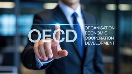 Professional touching screen displaying OECD acronym for economic cooperation and global development initiatives