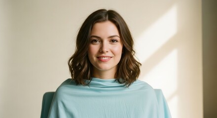 Fototapeta premium Smiling woman in light blue draped top