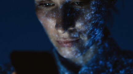Close-up woman with data mesh projection and smartphone glow.