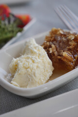 Delicious honeycomb and cream served at a rustic table