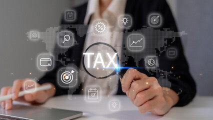 Adult Asian professional analyzing global tax information with digital magnifying glass on laptop for financial strategy and compliance