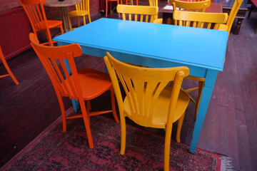 Colorful chairs and table in a vibrant cafe setting