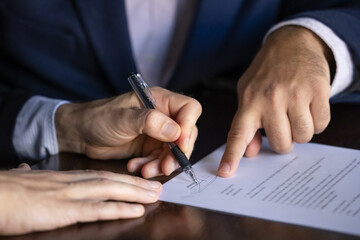Businessman put signature on formal contract, close up