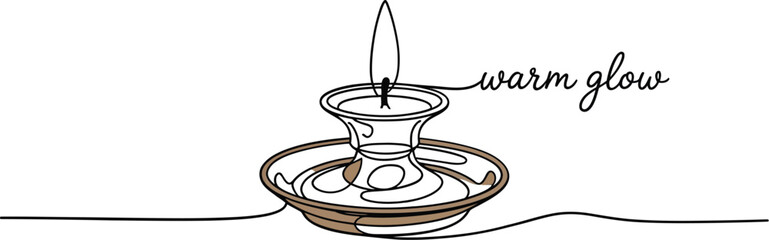 A vintage style candle in an ornate brass candlestick casts a warm inviting glow with the words warm glow written in elegant script next to the flame