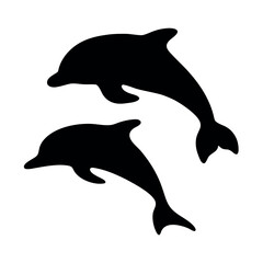 Two silhouetted dolphins leaping and playing together in the ocean water