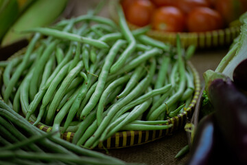 Fresh green beans beautifully arranged in a basket, showcasing farmfresh produce at a local market
