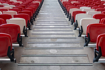 Red and white seating and staircase inside a giant stadium