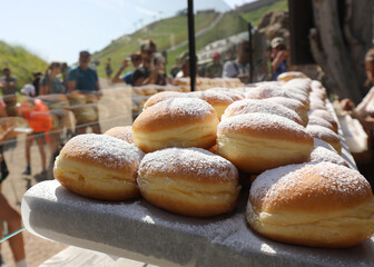 cream filled donuts with powdered sugar on top for sale in the mountain lodge along the alpine trail in fassa Valley in Italy