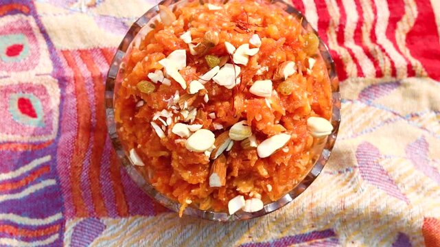 Gajar ka halwa is a sweet dessert pudding from India made from carrot, served in a bowl