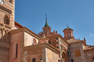 Mudejar tower of the Cathedral of Santa Maria de Mediavilla in Teruel with ornamental details and a blue sky in the background