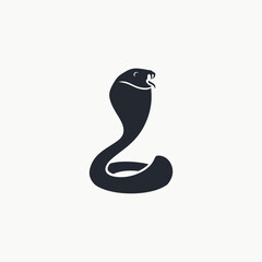 Fototapeta premium A powerful silhouette of a cobra with its hood spread, poised to strike, showing its fangs and tongue.