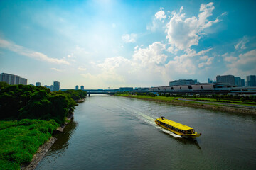 A cityscape of floating ship on the creek in Tokyo wide shot