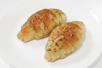 Shio Pan (Salted Butter Roll) Soft, fluffy bread with a golden crispy crust, filled with rich butter and a hint of sea salt. Savory, aromatic, and perfectly balanced in every bite. On white background