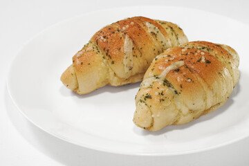 Shio Pan (Salted Butter Roll) Soft, fluffy bread with a golden crispy crust, filled with rich butter and a hint of sea salt. Savory, aromatic, and perfectly balanced in every bite. On white background