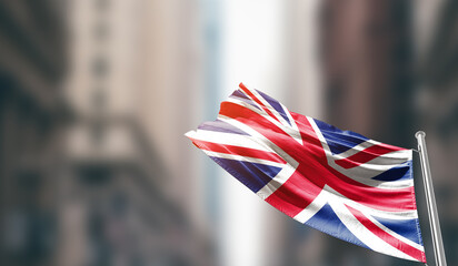 United Kingdom national flag waving on street. A beautiful with mast with blur buildings. UK...