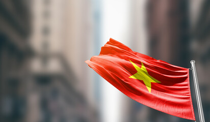 Vietnam national flag waving on street. A beautiful with mast with blur buildings. Vietnam national...