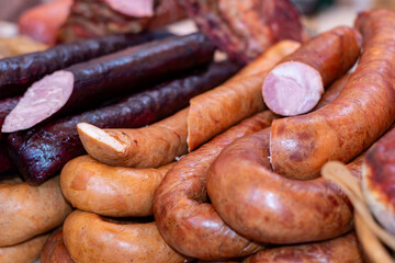 Fototapeta premium A variety of sausages at a street food market. Selective focus.