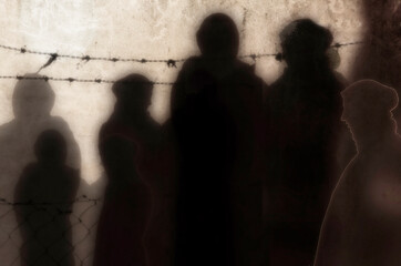 Refugee in Ukraine and Gaza and in the world showed as shadows on a wall with barbed wire