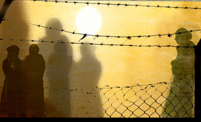 Refugee in Ukraine and Gaza and in the world showed as shadows on a wall with barbed wire