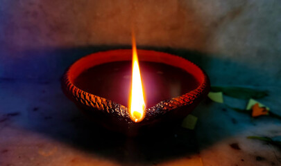 Single Clay Oil Lamp Glowing in Darkness