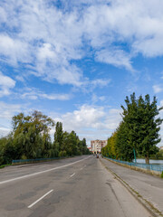 A view of a city street with cars driving down it