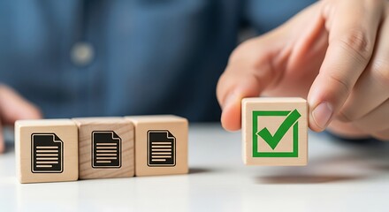 Document Confirmation Concept: A close-up shot captures a hand carefully selecting a wooden cube featuring a check mark, alongside other cubes with document icons.
