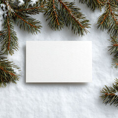 Fototapeta premium Winter holiday mockup with empty white card on snow, framed by fir tree branches. Perfect for Christmas greeting cards, holiday invitations, seasonal banners and festive designs.