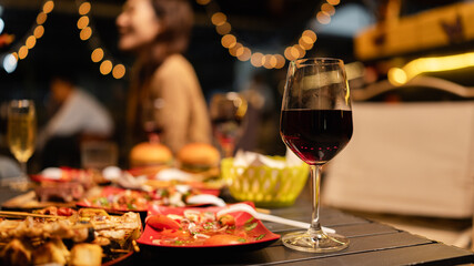 glasses of red on table at night.