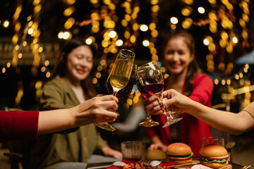 Party and celebration concept, Holidays summer, Group of friends clinking glasses wine on outdoor at night party.