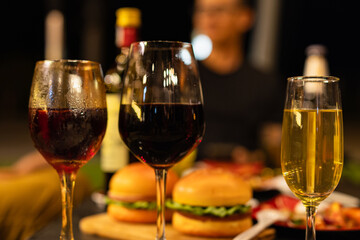 Party and celebration concept, Holidays summer, Group of friends clinking glasses with wine on outdoor at night party.