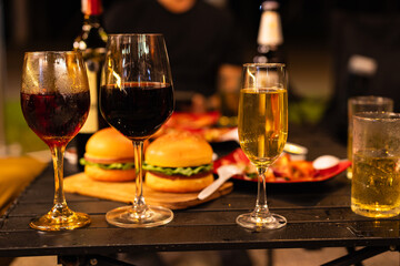 Party and celebration concept, Holidays summer, Group of friends clinking glasses with wine on outdoor at night party.