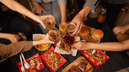 Party and celebration concept, Holidays summer, Group of friends clinking glasses with wine on outdoor at night party.