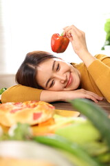 Happy young woman enjoying delicious homemade pizza at home.