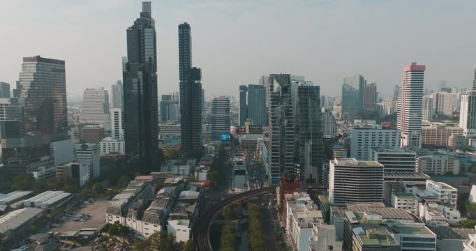Aerial view city office building with BTS train metropolitan mass transport modern skyline of Bangkok Thailand