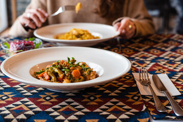 Dining with Colorful Dishes on Patterned Tablecloth