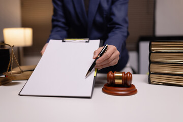 Lawyer businesswoman working diligently with signature document in a modern office, Signing...