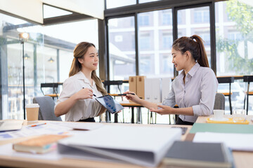 Businesswomen analyzing data on a tablet. Teamwork and planning for the future. Digital presentation and business discussion.