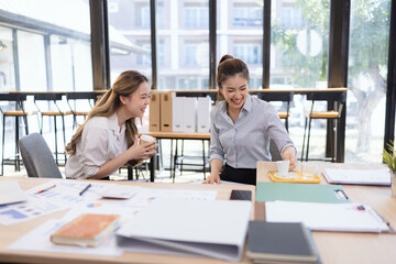 Two businesswoman colleagues having a casual conversation during a coffee break, Informal business meeting for new ideas and collaboration.