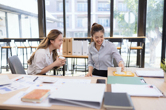 Two businesswoman colleagues having a casual conversation during a coffee break, Informal business meeting for new ideas and collaboration.