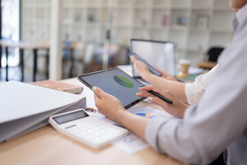 Team analyzing financial data and creating business strategies using digital tools.